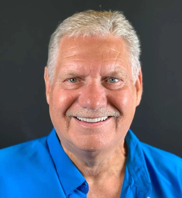 Patient smiling with the new upper implant bridge