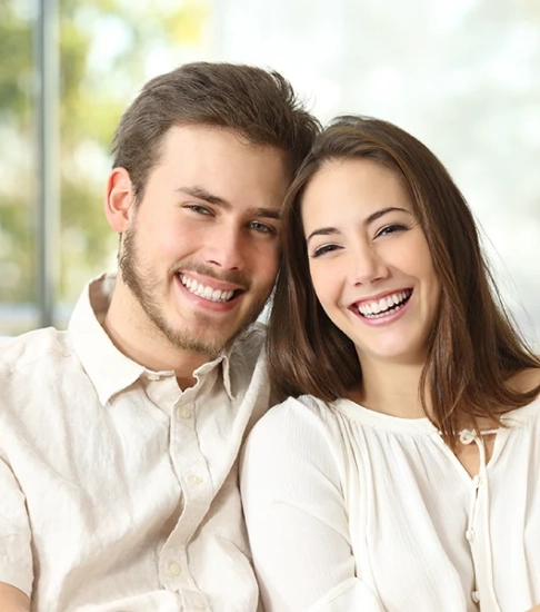 Smiling young couple sitting close together