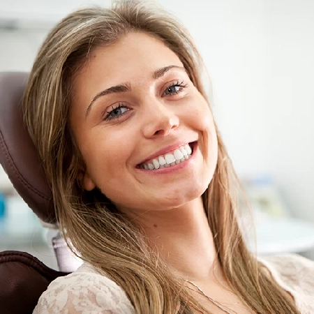 Smiling woman relaxing in a dental chair