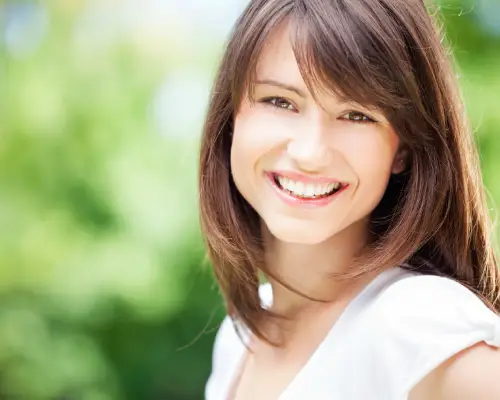 Smiling woman with bright white teeth after professional whitening