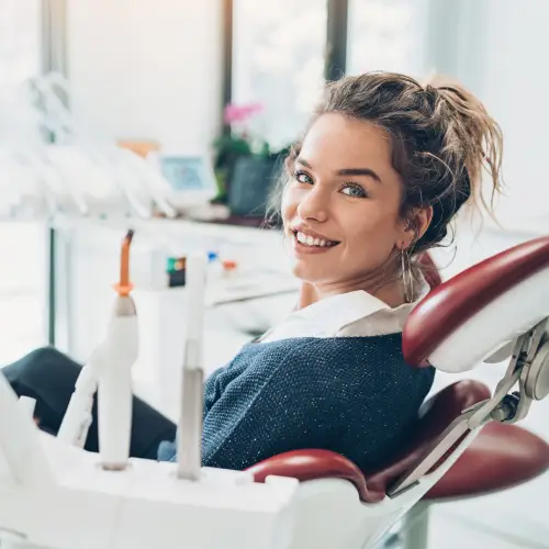 Smiling young woman seated in a dental chair