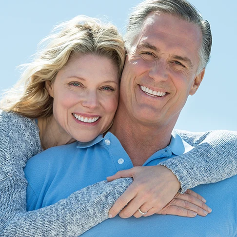 Smiling mature couple embracing outdoors