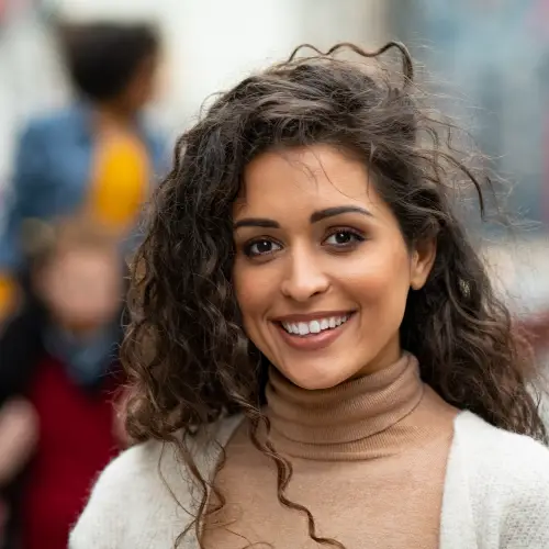 Smiling young woman with curly dark hair