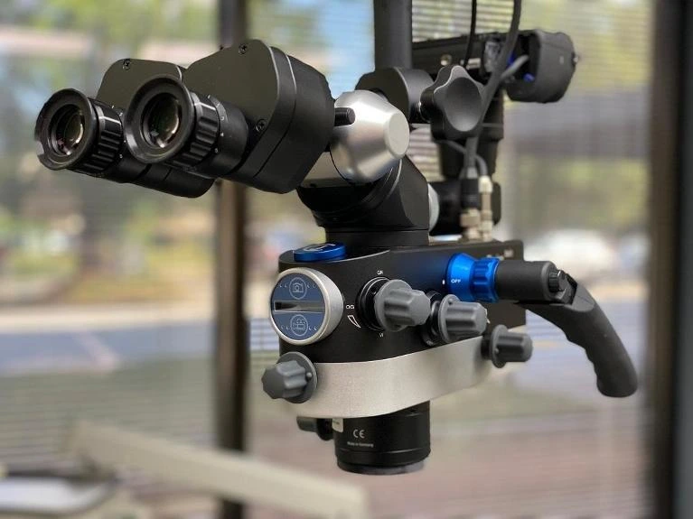 Dentist using an operating microscope during treatment
